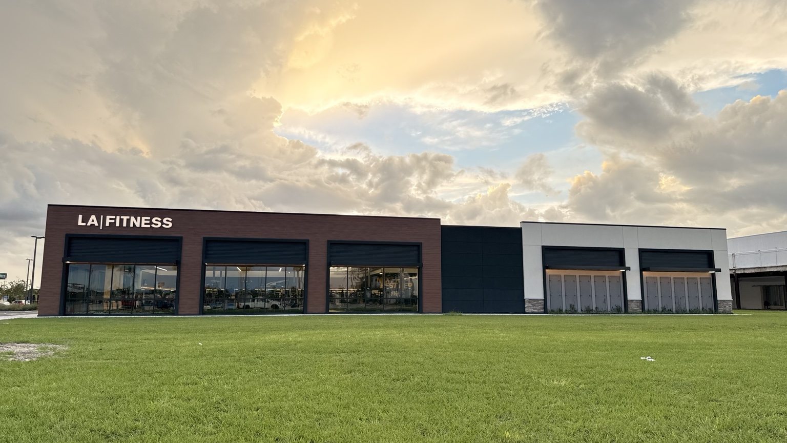 Wide view of the completed LA Fitness building exterior