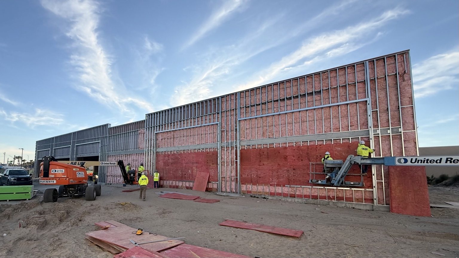 Wider exterior elevation with framing and sheathing in progress